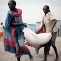 South Sudanese who fled recent ethnic violence carry food aid from a World Food Program distribution center in Pibor, South Sudan, Jan. 12.