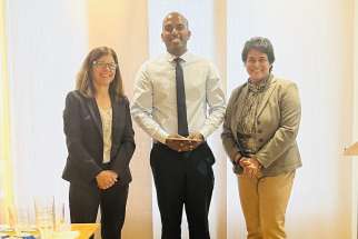 From left, Maureen Leon, board president of Catholic Charities of the Archdiocese of Toronto, scholarship winner Ronald Perinpanayagam and Agnes Thomas, executive director.