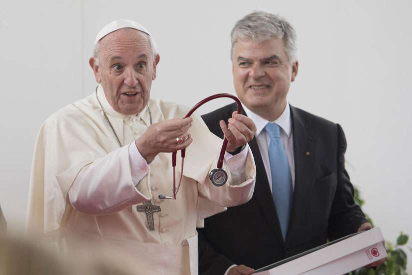 Pope Francis receives a stethoscope from the President of the European Society of Cardiology, Fausto Pinto, as he attends the World Congress of the European Society of Cardiology Aug. 31 in Rome.