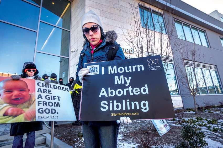 A woman mourns her sister’s death through a late-term abortion during a protest outside a Planned Parenthood facility in Washington. 