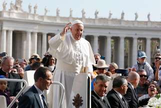 Pope Francis greets the crowd as he arrives to lead his general audience in St. Peter&#039;s Square at the Vatican April 26.