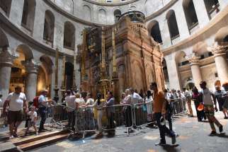 Tourists walk around the tomb in the Church of the Holy Sepulcher in Jerusalem&#039;s Old City, June 13, 2019. Following the successful cooperation on the 2016 restoration of the Edicule in the Church of the Holy Sepulcher, the leaders of the Greek Orthodox, Catholics and Armenian Orthodox, who serve as guardians of the holy site, have signed an agreement to continue with restorations, this time on the pavement and foundations around the tomb.
