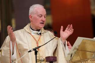 Cardinal Marc Ouellet, prefect of the Congregation for Bishops, and Cardinal Gerald Lacroix of Quebec City, concelebrate Mass July 26 at the Basilica of Ste.-Anne-de-Beaupre in Ste.-Anne-de-Beaupre, Quebec, on the feast of St. Anne. 