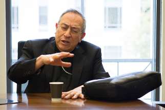 Cardinal Oscar Rodriguez Maradiaga of Tegucigalpa, Honduras, speaks to reporters at the Edward Bennett Williams Law Library at the Georgetown University Law Center in Washington Nov. 2. 