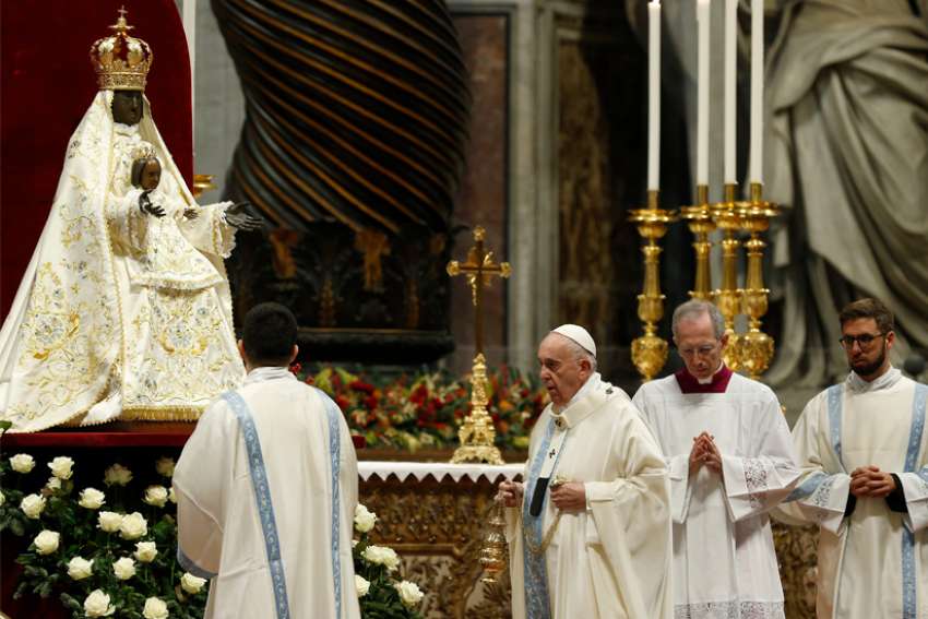 Pope Francis prepares to venerate a Marian statue as he celebrates Mass on the feast of Mary, Mother of God, in St. Peter&#039;s Basilica at the Vatican Jan. 1, 2020.