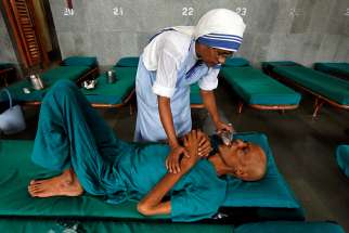A member of the Missionaries of Charity tends to a patient in 2016 in Kolkata, India. Indian officials are seeking to freeze bank accounts of the Missionaries of Charity following the July 5 arrest of a nun on child trafficking charges. 