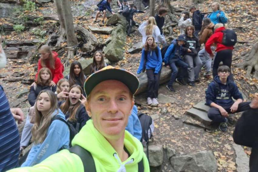 Leon Blais takes a selfie with a group of students on retreat, where he shared his personal conversion story.