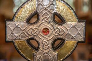 The top of the processional cross that will be used at the coronation of King Charles III in May is seen on the altar of an Anglican parish in Llandudo, Wales, April 19, 2023. Relics of the Christ&#039;s cross, a gift from Pope Francis, are under glass in the centre of the processional cross.