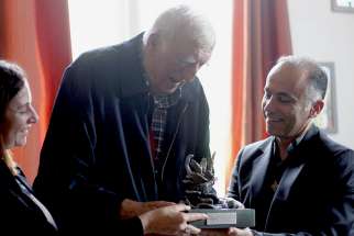 Father Fadi Daou, right, president of Adyan, and Nayla Tabbara, also of Adyan, present the Spiritual Solidarity Award to Jean Vanier, founder of the International Federation of L&#039;Arche Communities, Oct. 6 in Trosly, France. Adyan is a foundation for interreligious studies and spiritual solidarity based in Lebanon. 