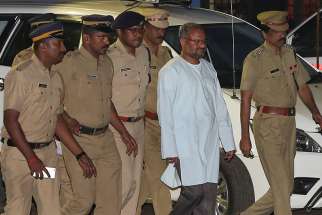 Bishop Franco Mulakkal of Jalandhar, India, is led away for questioning by police on the outskirts of Cochin Sept. 21, 2018. Indian police have charged Bishop Mulakkal of repeatedly raping a nun in her rural convent, the Associated Press reported April 9, 2019.