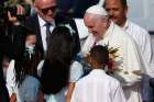 Pope Francis accepts flowers from children as he arrives at Antonio Maceo International Airport in Santiago, Cuba.