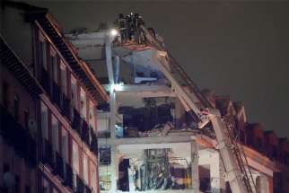 Firefighters work after a deadly explosion at the parish center of the Church of Our Lady of La Paloma in downtown Madrid Jan. 20, 2021. A priest and a member of the parish were among four killed in the explosion, which was caused by a gas leak.