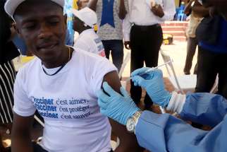 A World Health Organization worker administers a vaccination May 21 during the launch of a campaign aimed at beating an outbreak of Ebola in Mbandaka, Congo.