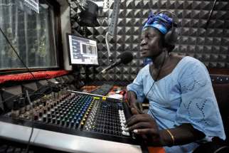 Melania Itto, program manager of Radio Bakhita, hosts the morning &quot;Juba Sunrise&quot; program in the station&#039;s studio in Juba, Southern Sudan. Radio Bakhita has been silent since Aug. 16 when South Sudan’s National Security Service stormed into the station and arrested its news editor.