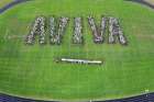 Students at St. Benedict Catholic High School in Cambridge Ont., show their appreciation on the soon-to-be upgraded sports field for the $100,000 awarded to it by the Aviva Community Fund to help pay for those improvements.