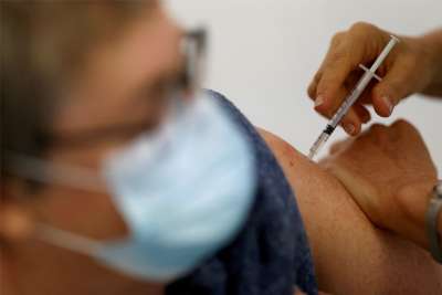 Health care workers denied religious exemption on vaccine win settlement