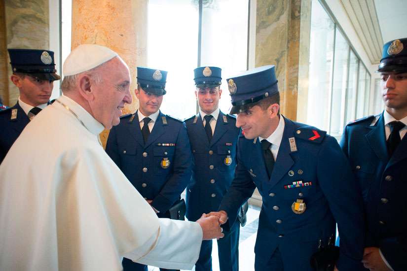 Pope Francis greets Vatican police officers after celebrating a Mass for them at the Vatican in 2015. The Pope celebrated Mass on the 200th anniversary of the Corps of the Vatican Gendarmes, Sept. 18.