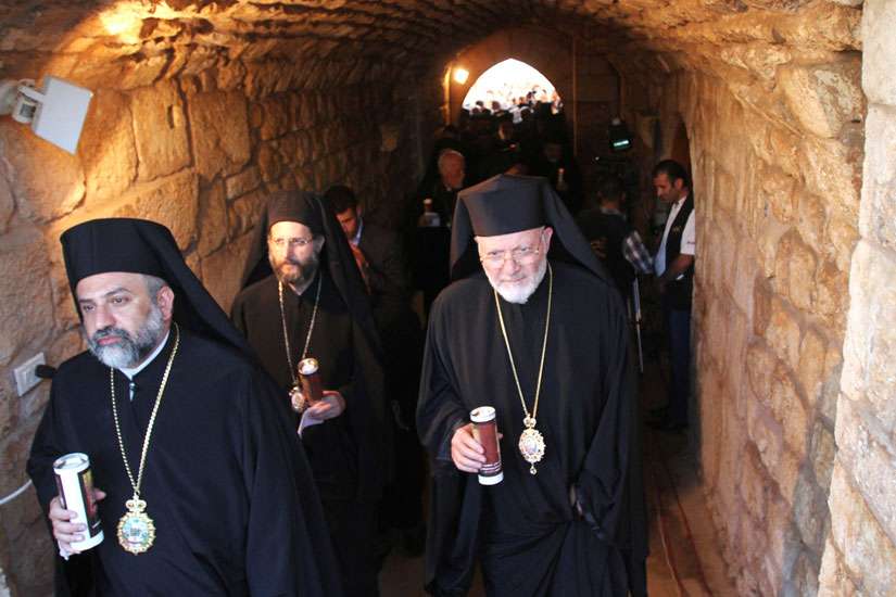 Members of the clergy hold candles during a vigil at the Balamand Monastery in Koura, Lebanon, June 22, to pray for the release of bishops kidnapped in northern Syria. Orthodox Metropolitan Paul of Aleppo and Syriac Orthodox Metropolitan Gregorios Yohanna of Aleppo were kidnapped April 22, 2013 in northern Syria while on a humanitarian mission.