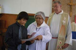 Rosella Kinsohameg with Fr. Doug McCarthy at her grandson Tanner’s First Communion.