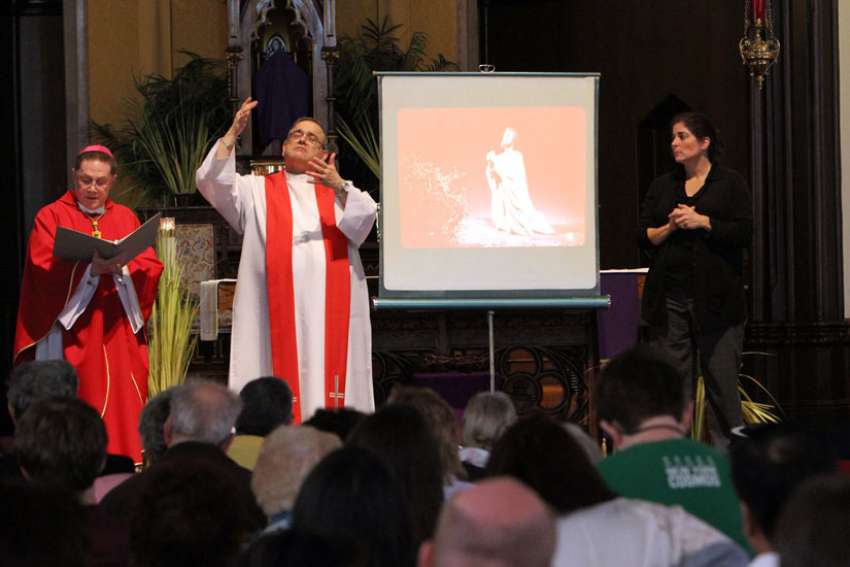 Auxiliary Bishop Andrzej J. Zglejszewski of Rockville Centre, N.Y. signs at a Mass. Spanish Conference of Catholic Bishops Deaf Ministry holds sign language at around 24 churches every week.