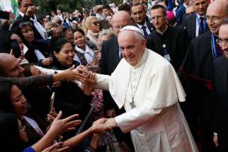 Pope Francis greets the faithful as he arrives to celebrate Mass at the Church of the Immaculate Conception in Baku, Azerbaijan, Oct. 2.