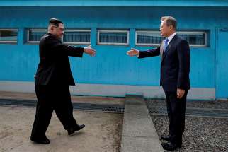South Korean President Moon Jae-in, right, a practising Catholic, and North Korean leader Kim Jong Un shake hands inside the demilitarized zone separating the two Koreas April 27.