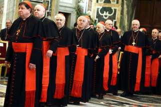 Cardinals wait in line to meet Pope Francis during his annual pre-Christmas meeting with top officials of the Roman Curia at the Vatican in this Dec. 21, 2017, file photo. The pope is planning a major reorganization of the Roman Curia.