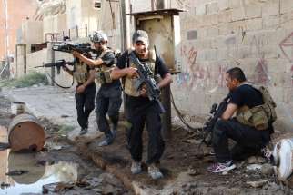 Members of the Iraqi Special Operations Forces take their positions during clashes with the militant Islamic State of Iraq and the Levant in the city of Ramadi June 19.  Chaldean Patriarch Louis Sako called the current situation in Iraq “perhaps the darkest and most difficult period in (the Church’s) recent history.”