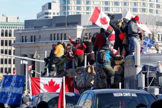 Trucks block a downtown road as truckers and supporters take part in a convoy to protest the COVID-19 vaccine mandates for cross-border truck drivers, in Ottawa, Ontario, Jan. 29, 2022.