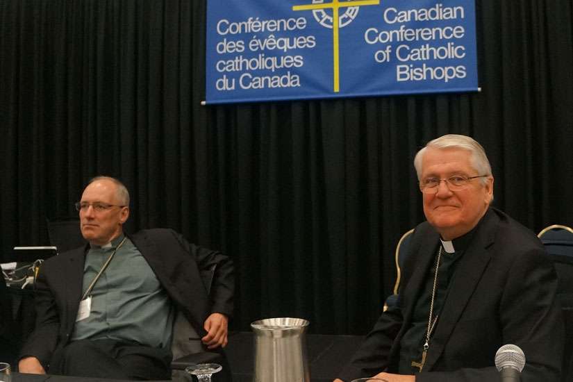 Bishop Douglas Crosby, right , spoke at a news conference Sept. 18 to wrap up the bishops’ annual plenary.