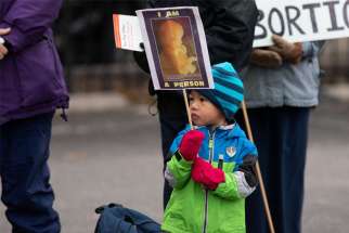 A child takes part in a March for Life rally in Dallas Jan. 15, 2022. A leak of a draft majority opinion written by Justice Samuel Alito was revealed May 2, 2022, preparing for a majority of the court to overturn the landmark Roe v. Wade abortion rights decision later this year.