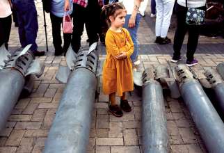 A girl looks on at a display of Russian weapon systems used in their attacks, outside St. Michael’s Cathedral in Kyiv, Ukraine. During the month of November, Pope Francis is asking people to pray for children who are suffering because of poverty, war and exploitation. 