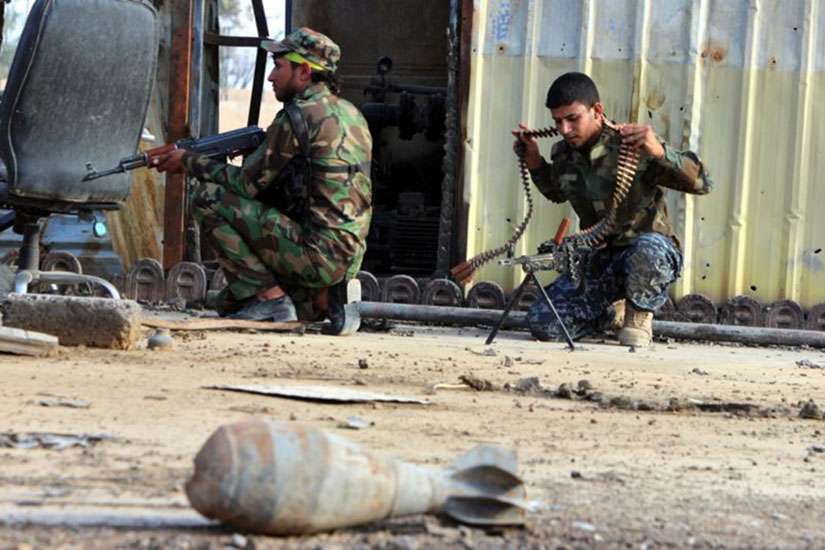 Shiite militia volunteers take positions against Islamic State forces near Baiji, Iraq, Oct. 25.