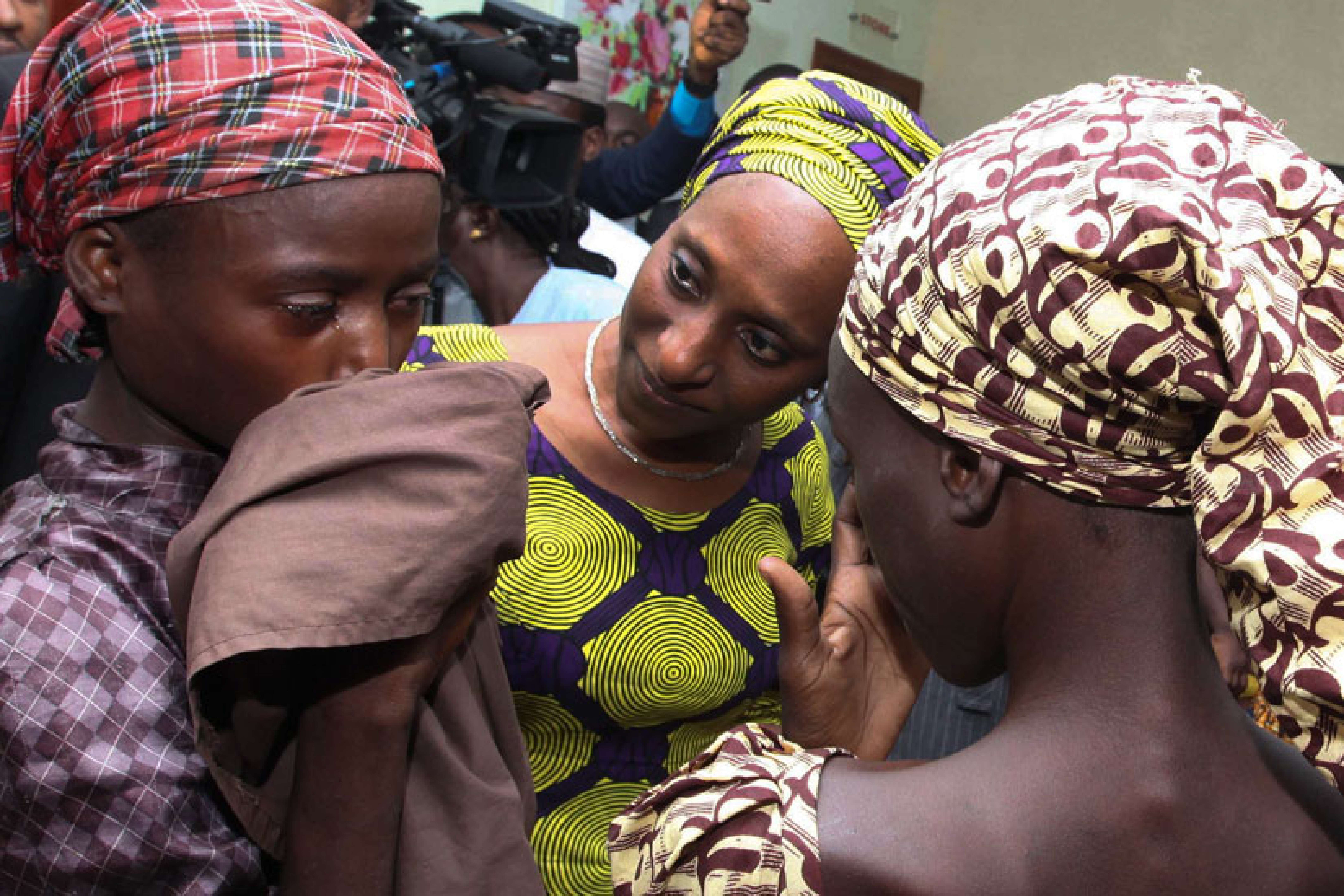 Oludolapo Osinbajo, wife of Nigerian Vice President Yemi Osinbajo, consoles one of the 21 released Chibok girls Oct. 13 in Abuja. Three Catholic leaders welcomed the release of some of the girls kidnapped in 2014 from a school in Chibok and urged the Nigerian government to prioritize the release of the remaining girls.