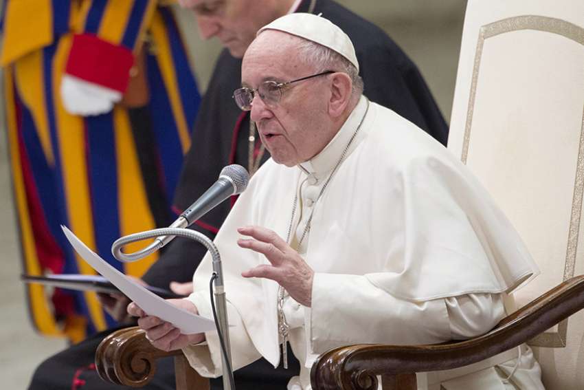 Pope Francis gestures during his Dec. 28 weekly audience in Paul VI hall at the Vatican.