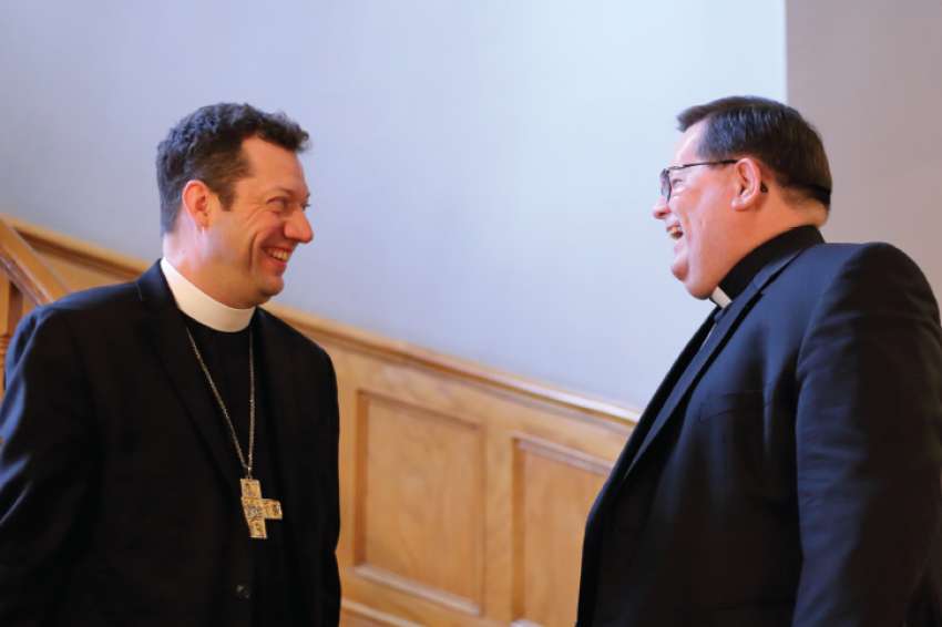 Cardinal Gerald Cyprien Lacroix, archbishop of Quebec, right, and Anglican Bishop Bruce Myers of Quebec share a laugh in Old Quebec’s Episcopal Palace. 