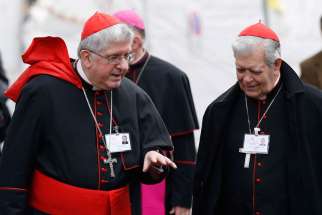 Cardinals Thomas Collins of Toronto and Jorge Urosa Savino of Caracas, Venezuela, talk as they arrive for a session of the Synod of Bishops on the Family at the Vatican Oct. 14.
