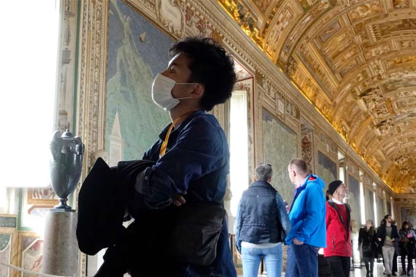  A visitor wears a mask for protection from the coronavirus while touring the Vatican Museums in this Feb. 29, 2020, file photo.