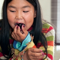 Kedra Kimiksana gets her first taste of a cherry.