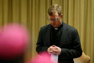 Jesuit Father Hans Zollner, president of the Centre for Child Protection at the Pontifical Gregorian University in Rome, prays at the start of the third day of the meeting on the protection of minors in the church at the Vatican Feb. 23, 2019.