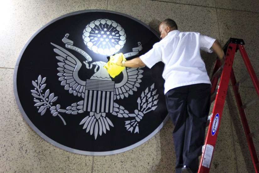 A worker cleans the seal of the United States of America after it was placed on the wall at the main entrance of the U.S. Embassy in Havana Aug. 14. U.S. Secretary of State John Kerry officially reopened the U.S. Embassy in Cuba.