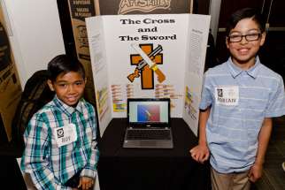 Grade five students from St. Justin Martyr Catholic School in Markham, Roy Halog and Adrian di Paolas (left to right), showcase their game The Cross and the Sword.