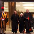 Swiss Guards stand at attention as Spanish Cardinals Julian Herranz, a retired Vatican official, and Antonio Canizares Llovera, prefect of the Congregation for Divine Worship and the Sacraments, and Austrian Cardinal Christoph Schonborn of Vienna leave a fter attending a vespers service with Pope Benedict XVI in the synod hall at the Vatican Feb. 17.