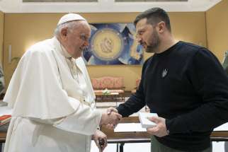 Pope Francis and Ukrainian President Volodymyr Zelenskyy shake hands after their meeting at the Vatican May 13, 2023.