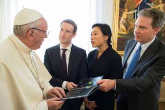 Pope Francis talks to Facebook CEO Mark Zuckerberg, second from left, and his wife Priscilla Chan during a meeting at the Vatican on August 29, 2016. Vatican spokesman Greg Burke is at far right.
