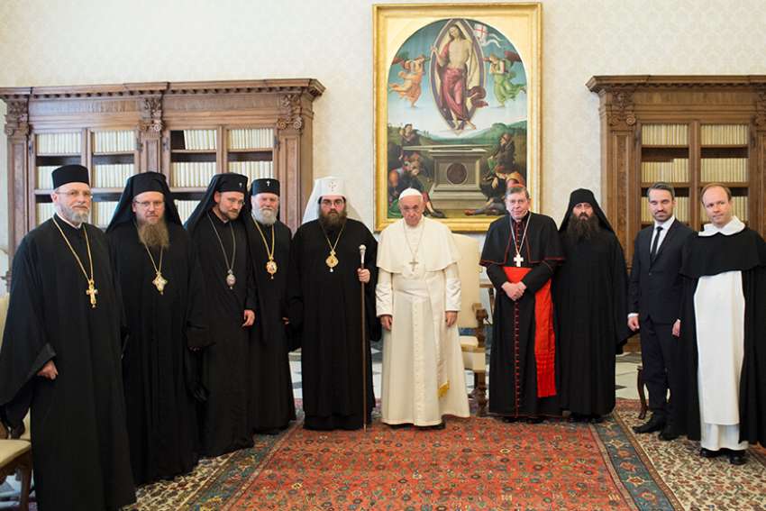 Pope Francis is flanked by Metropolitan Rastislav, primate of the Orthodox Church in the Czech and Slovak Republics, and Cardinal Kurt Koch, president of the Pontifical Council for Promoting Christian Unity, during a meeting in the Apostolic Palace at the Vatican May 11. The Pope said seeking Christian unity is more urgent than ever because of the ongoing persecution of Christians. 