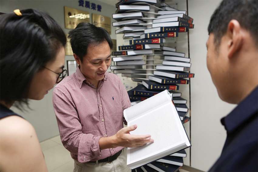 Scientist He Jiankui shows &quot;The Human Genome,&quot; a book he edited, at his company. Direct Genomics, in Shenzhen, China, Aug.4, 2016. An ethicist calls Jiankui&#039;s gene editing on a human embryo &quot;a train wreck of a thing to do.&quot; 