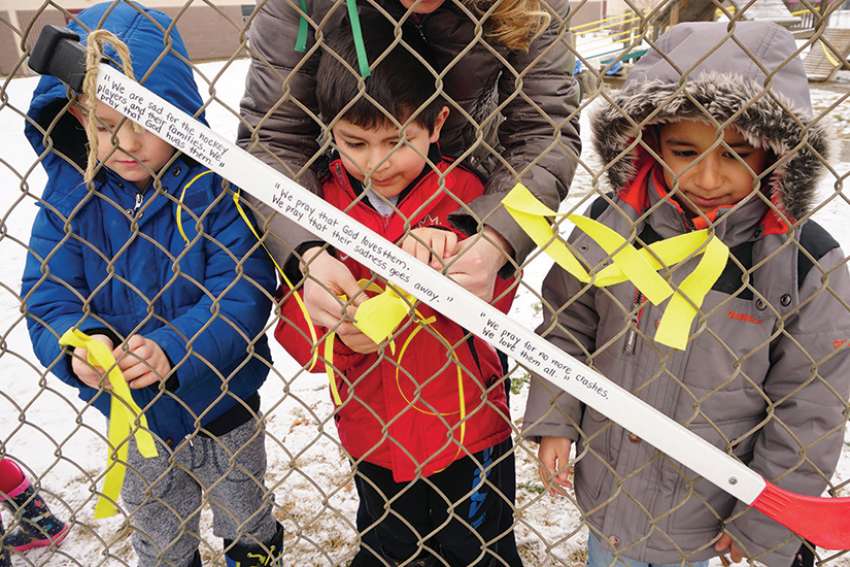 In the aftermath of the Humboldt tragedy, students at St. Monica’s School in Edmonton tied prayer sticks to the fence in the schoolyard, one of many memorials around the country.