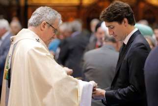 Prime Minister Justin Trudeau receives Communion during the ceremonial Mass May 17 at Notre-Dame Basilica in Montreal for the city&#039;s 375th birthday celebrations.