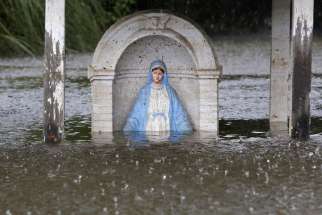 A statue of Mary is seen partially submerged in flood water in Sorrento, La., Aug. 20.